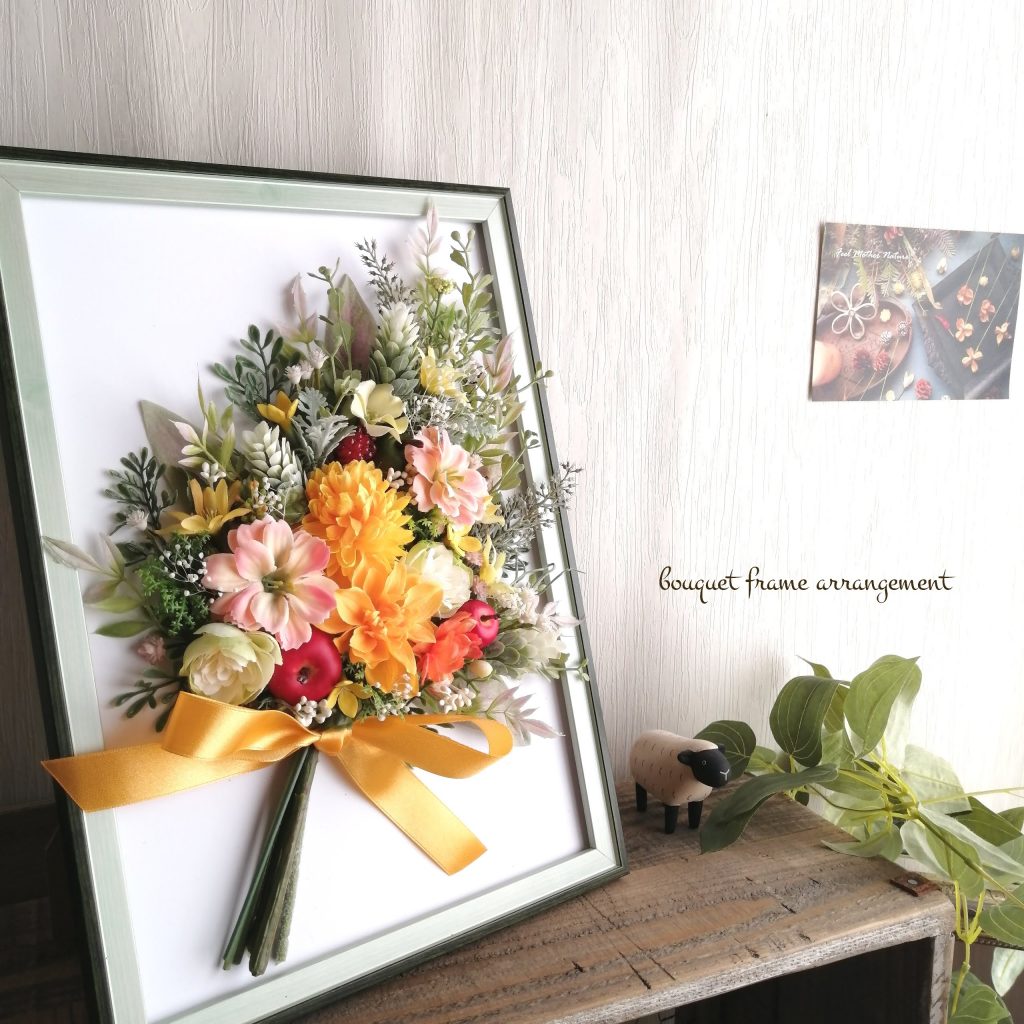 高品質な造花であるアーティフィシャルフラワーのビタミンカラーの花束フレームを飾ったイメージ